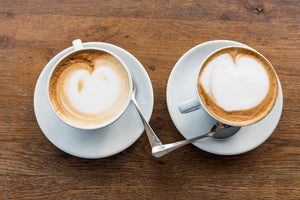 best coffee shops in austin texas - two lattes on a wooden table