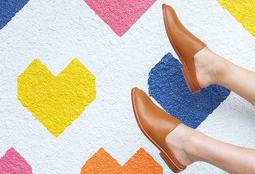 what to wear wednesday - woman wearing fortress of inca flat leather mules on colorful rug