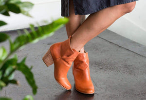 woman wearing ani rust fotress of inca boots crossing leg