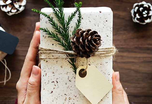 person holding a sustainable holiday gift tied with twine
