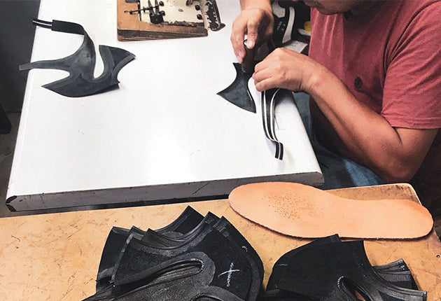 peruvian shoe maker cutting leather to make fortress of inca leather shoes 