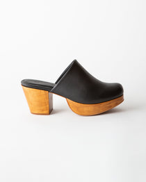 Black clog shoe with wooden sole on a white background