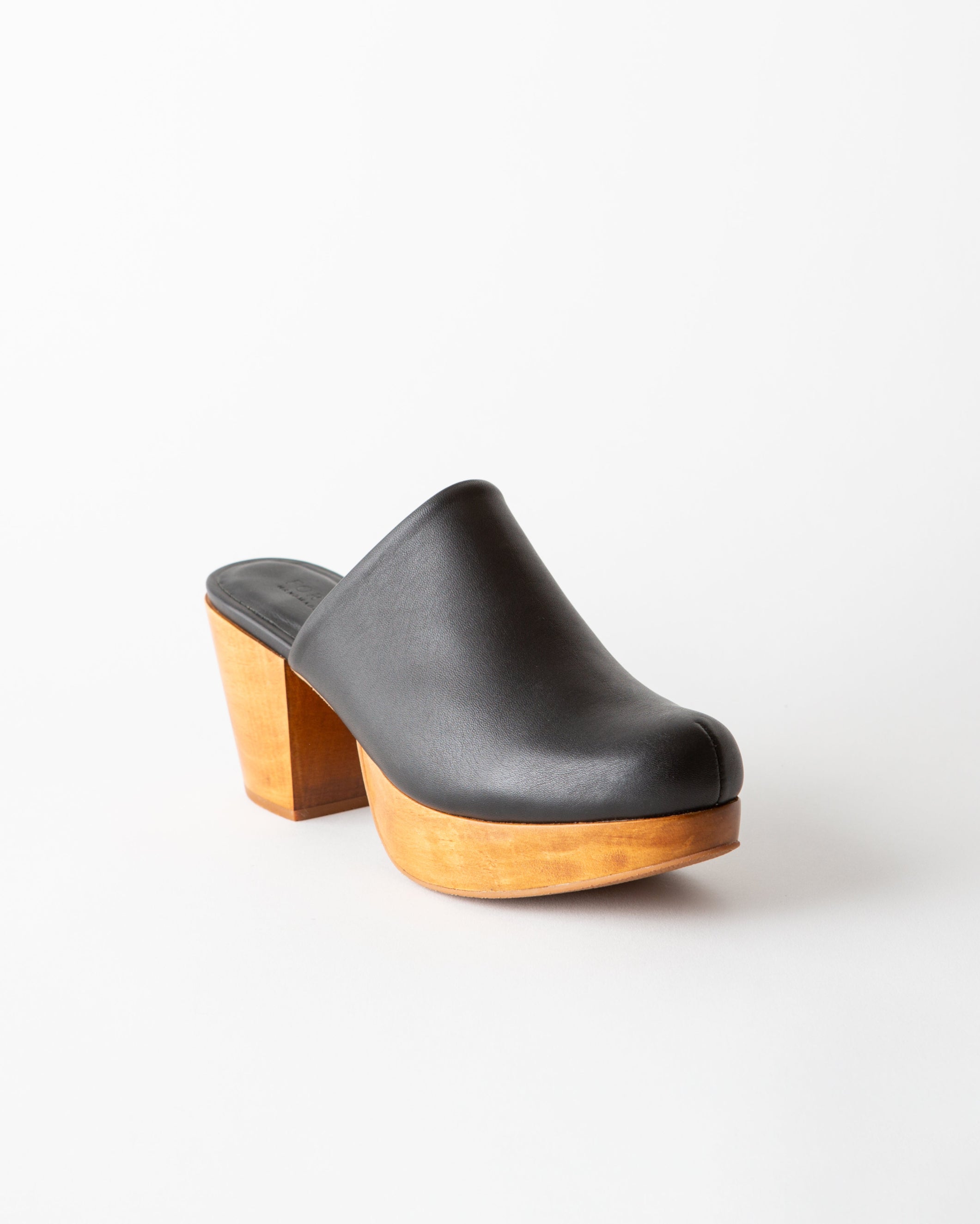 Black leather clog with wooden sole on a white background