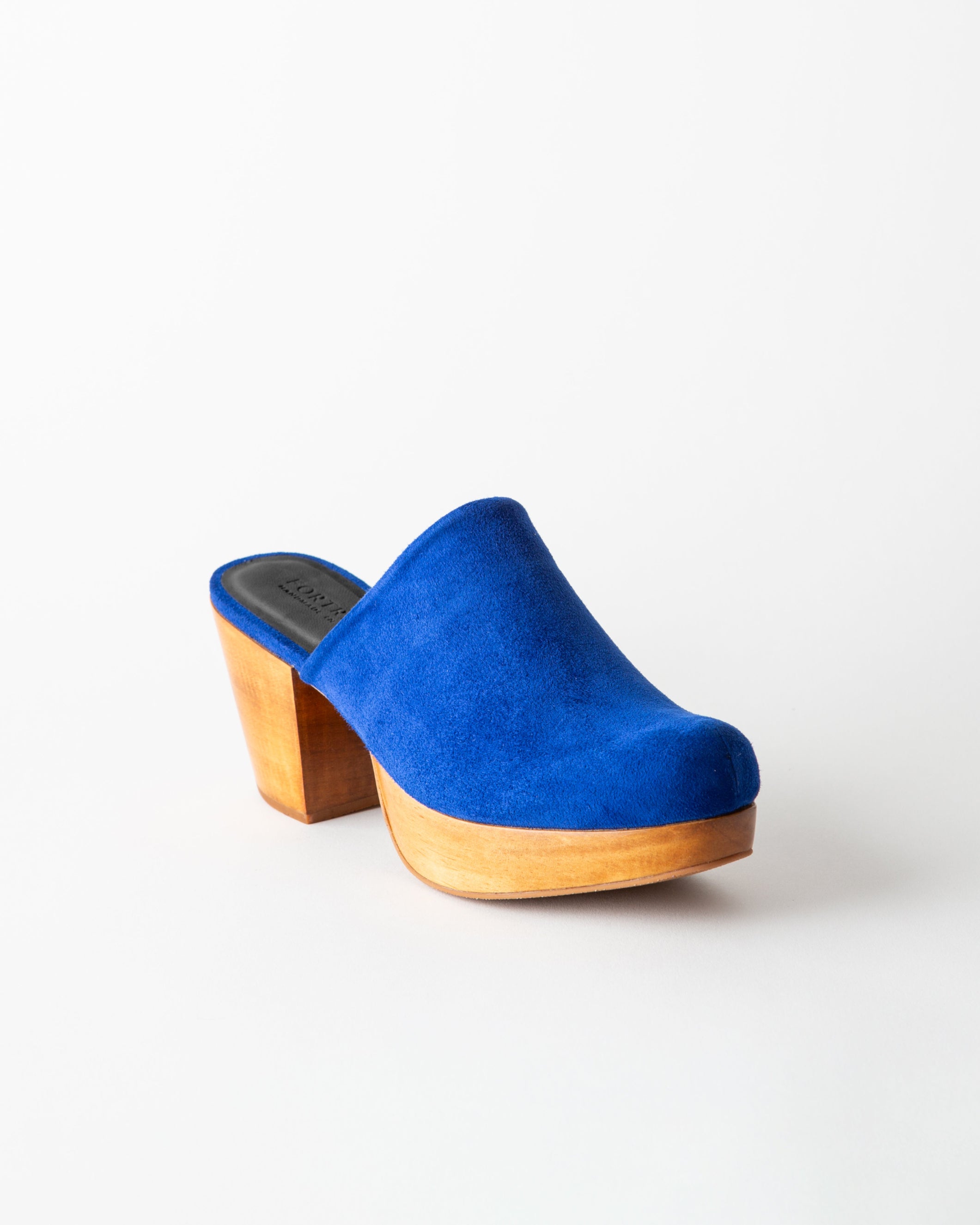 Blue suede clog shoe on a white background