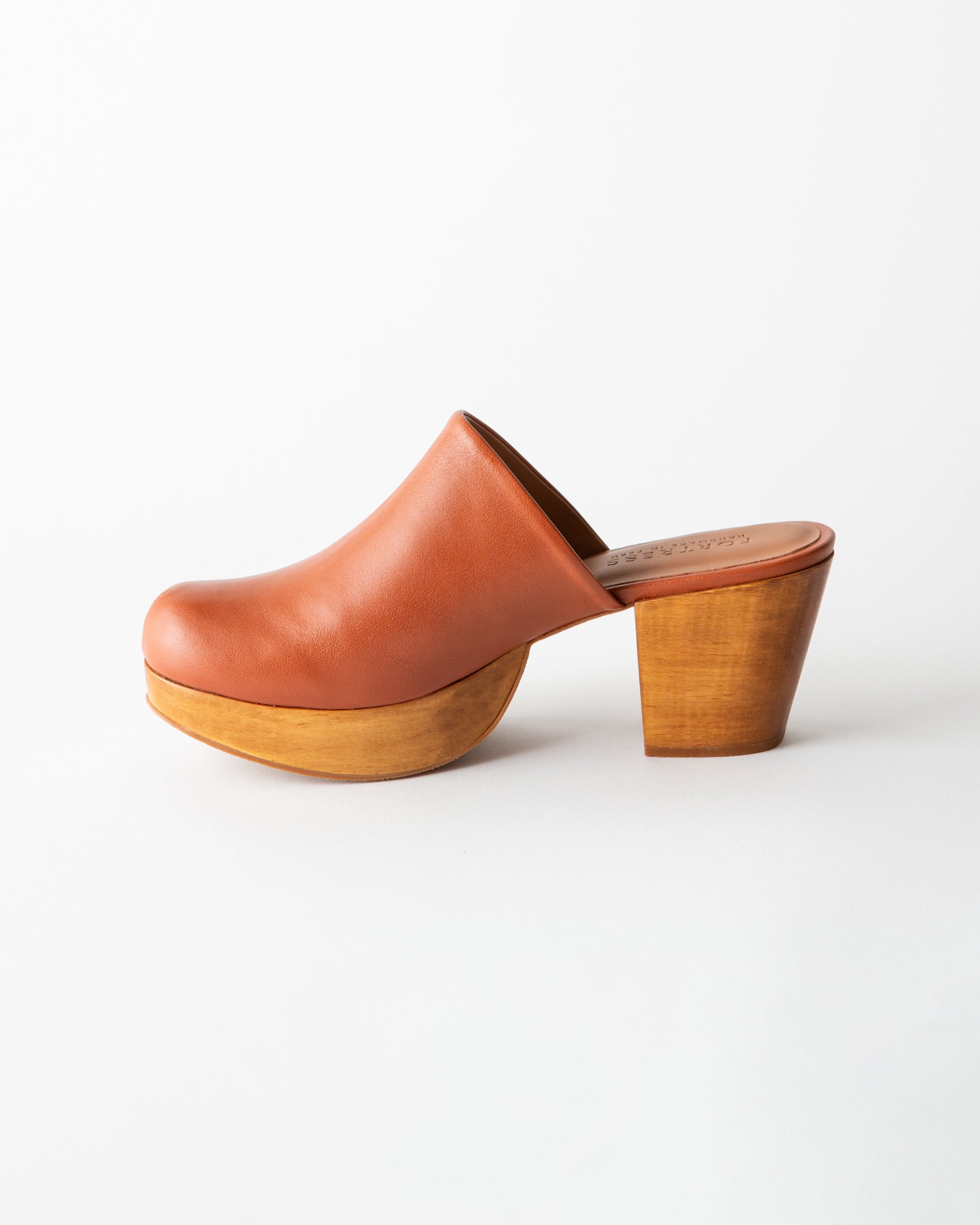Brown leather clog shoe with wooden sole on a white background