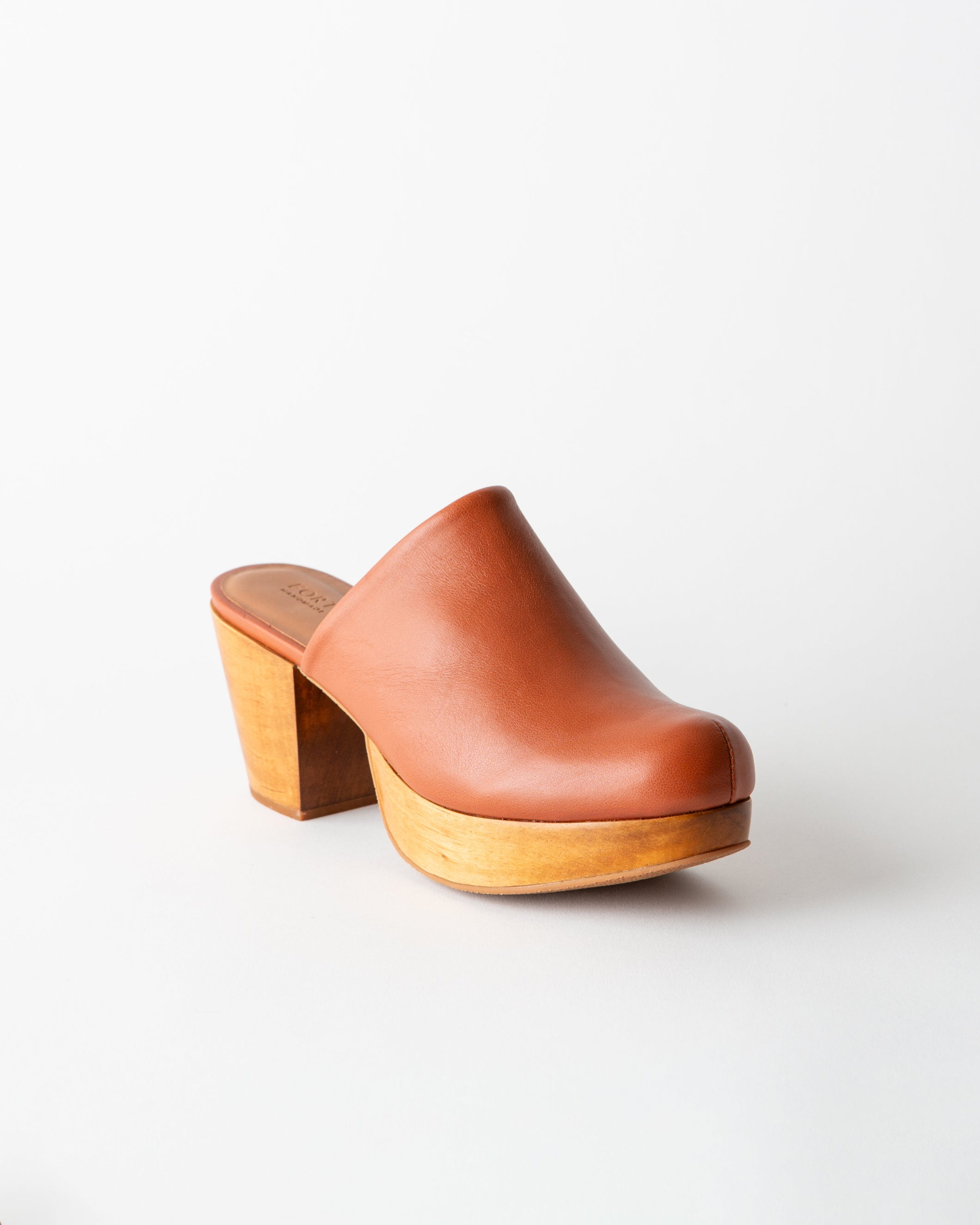 Brown leather clog shoe on a white background