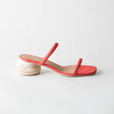 Red sandal with a wooden heel on a light gray background