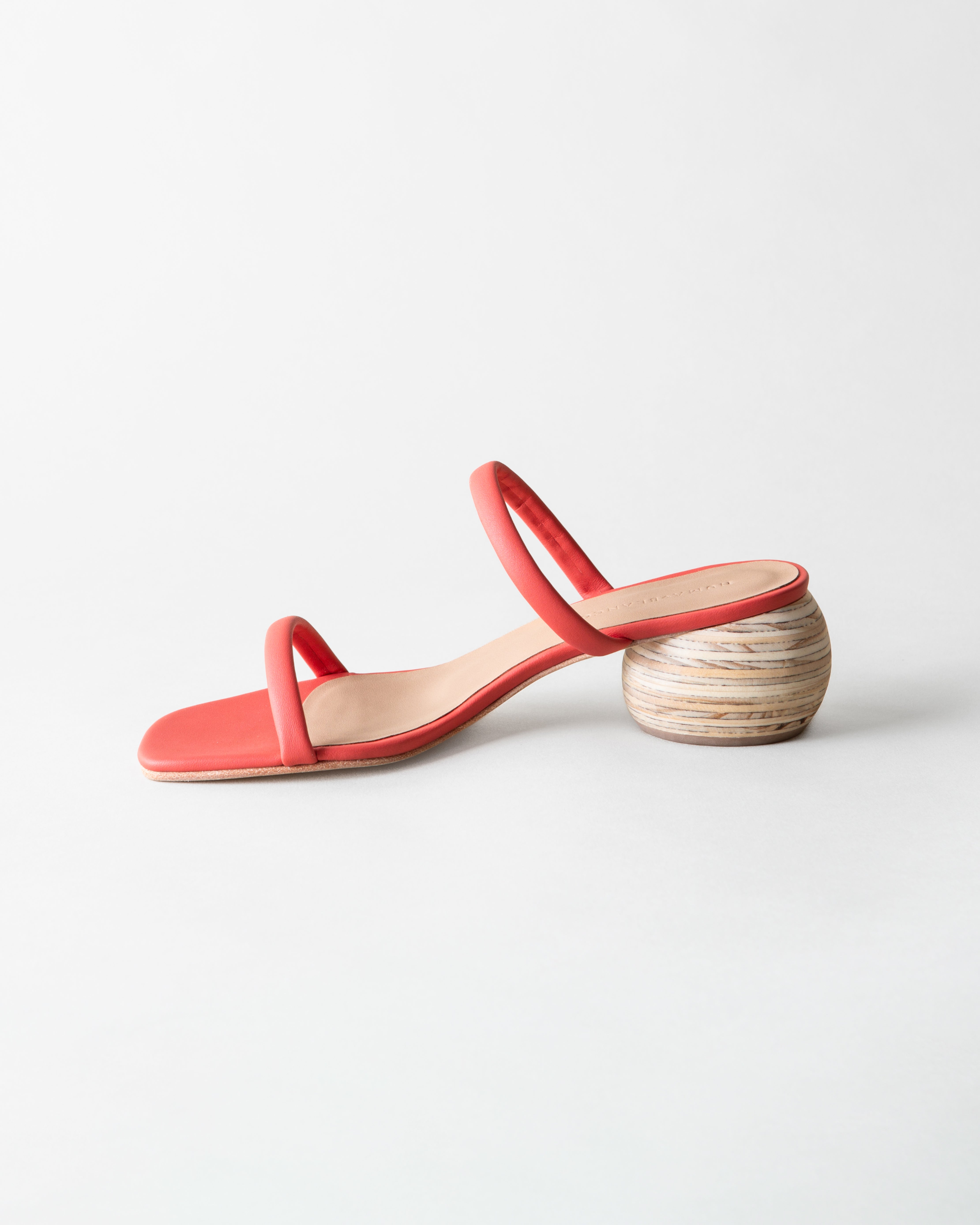 Coral sandal with wooden heel on a light gray background