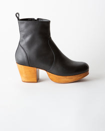 Black leather ankle boot with wooden heel on a white background