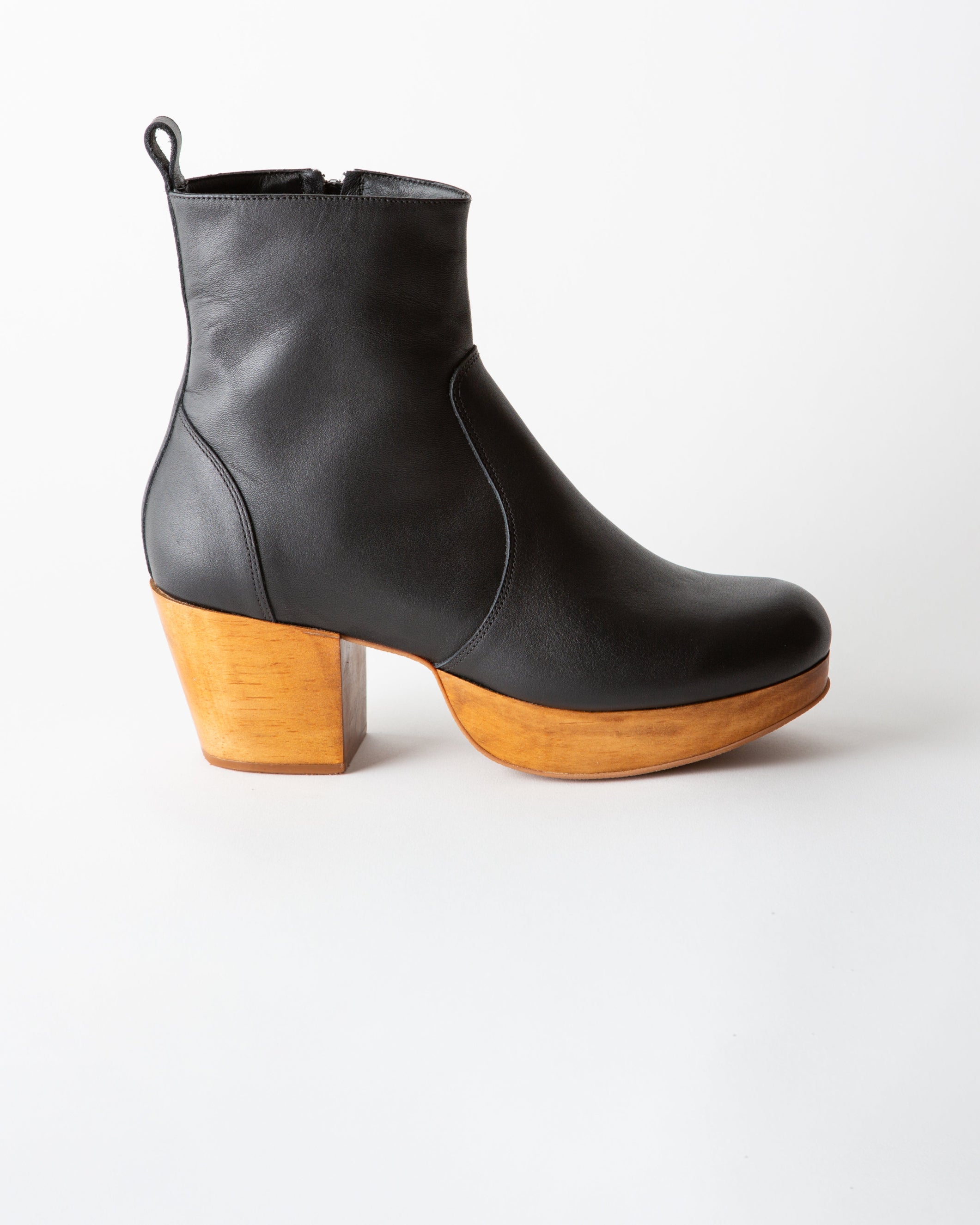 Black leather ankle boot with wooden heel on a white background
