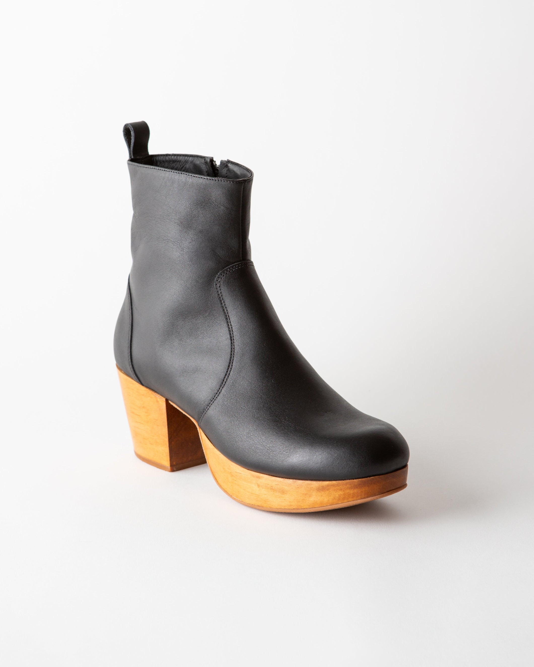 Black ankle boot with wooden heel on a white background