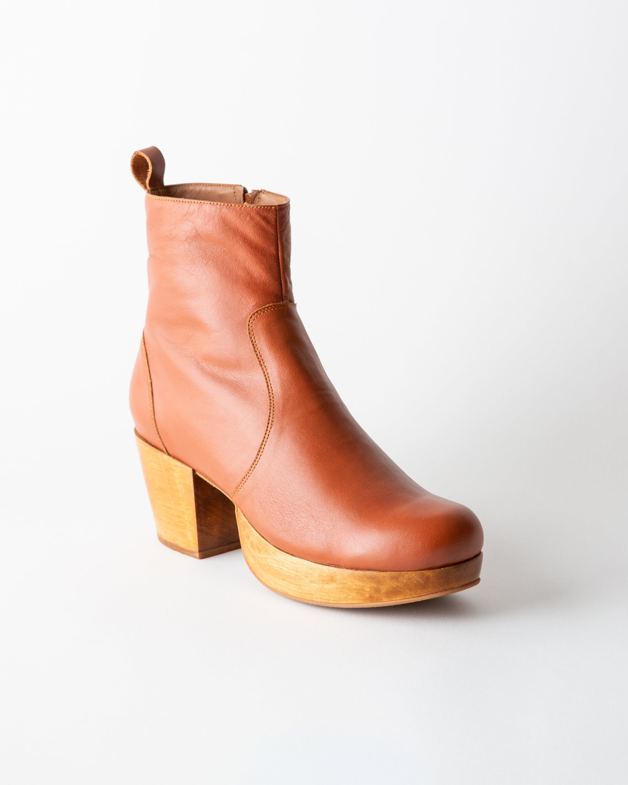 Brown leather ankle boot with wooden heel on a white background