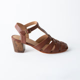 Brown sandal with a block heel on a white background
