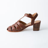 Brown sandal with wooden block heel on a white background