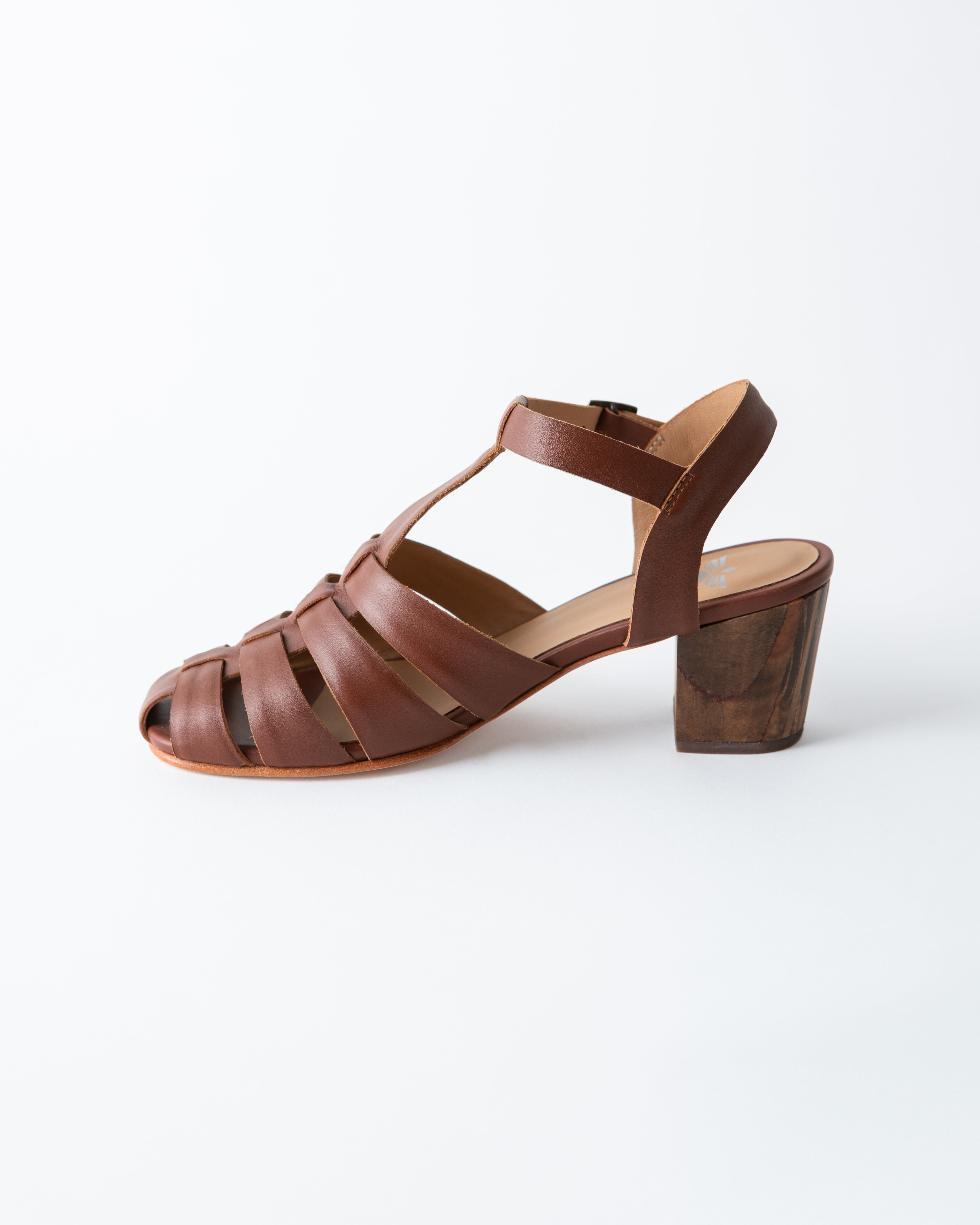 Brown sandal with wooden block heel on a white background
