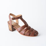 Brown sandal with a block heel on a white background