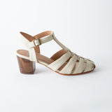 White sandal with wooden block heel on a white background
