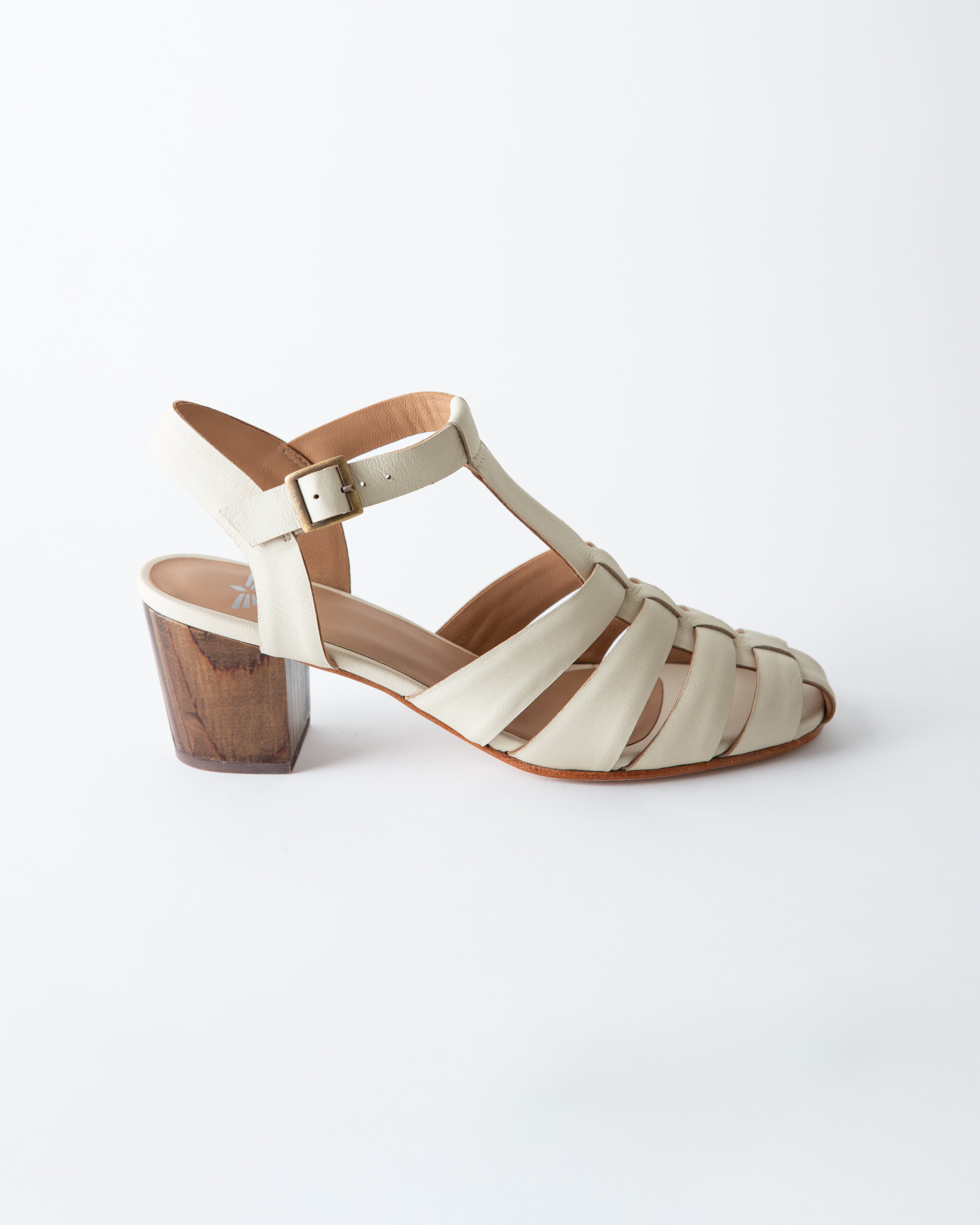 White sandal with wooden block heel on a white background