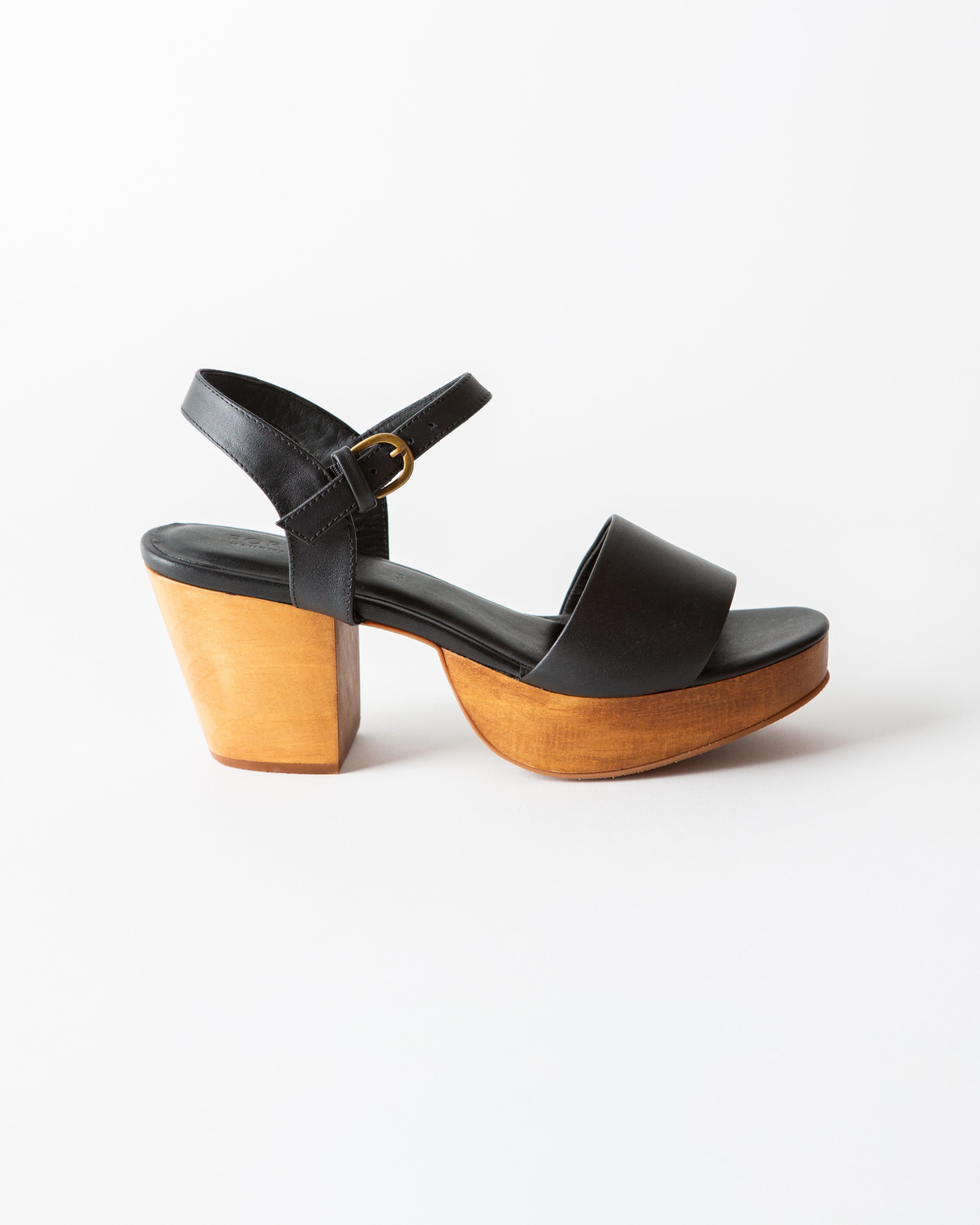 black leather clog sandal on a white background