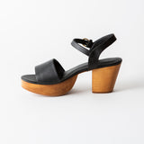 black leather clog sandal on a white background
