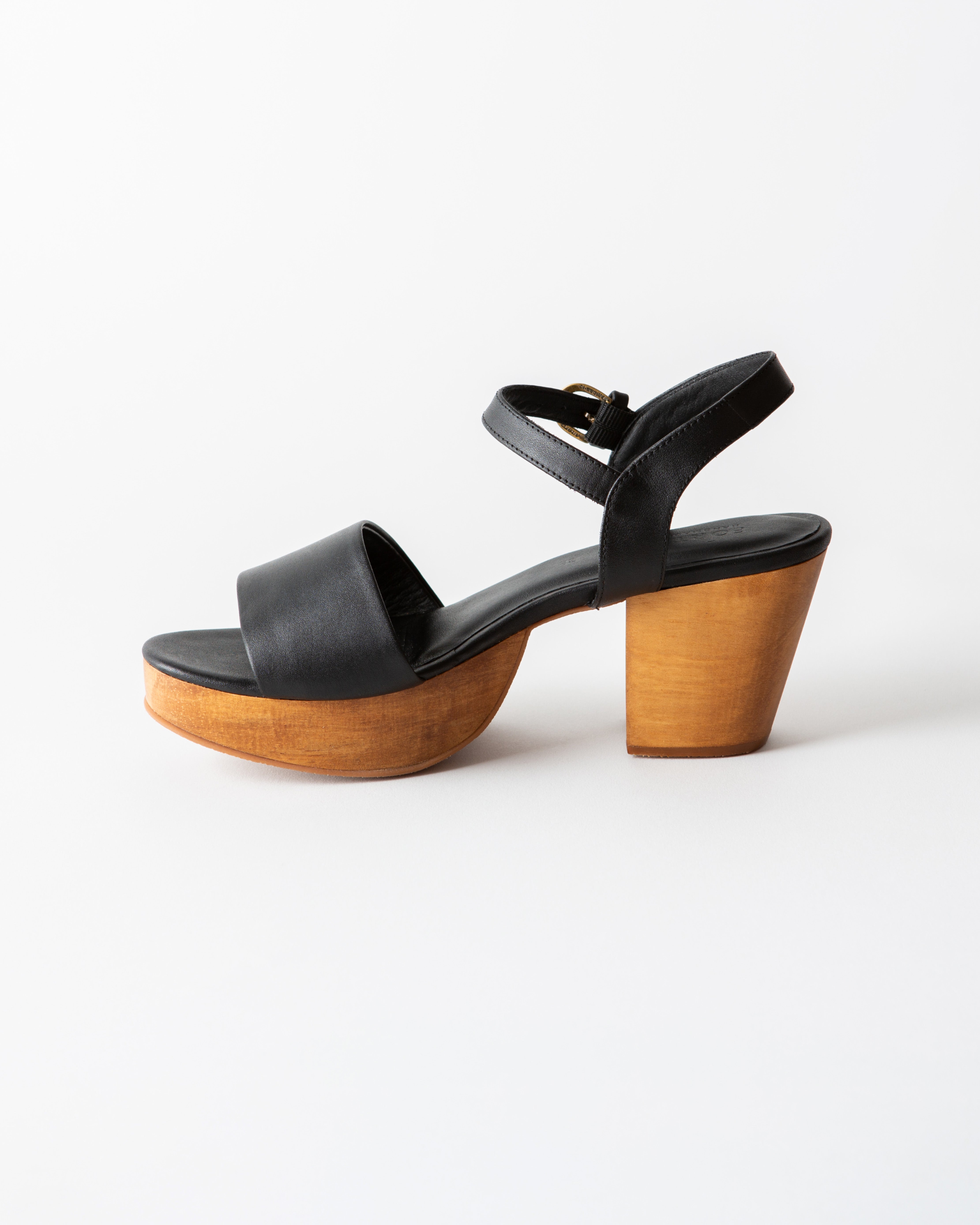 black leather clog sandal on a white background