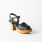 black leather clog sandal on a white background
