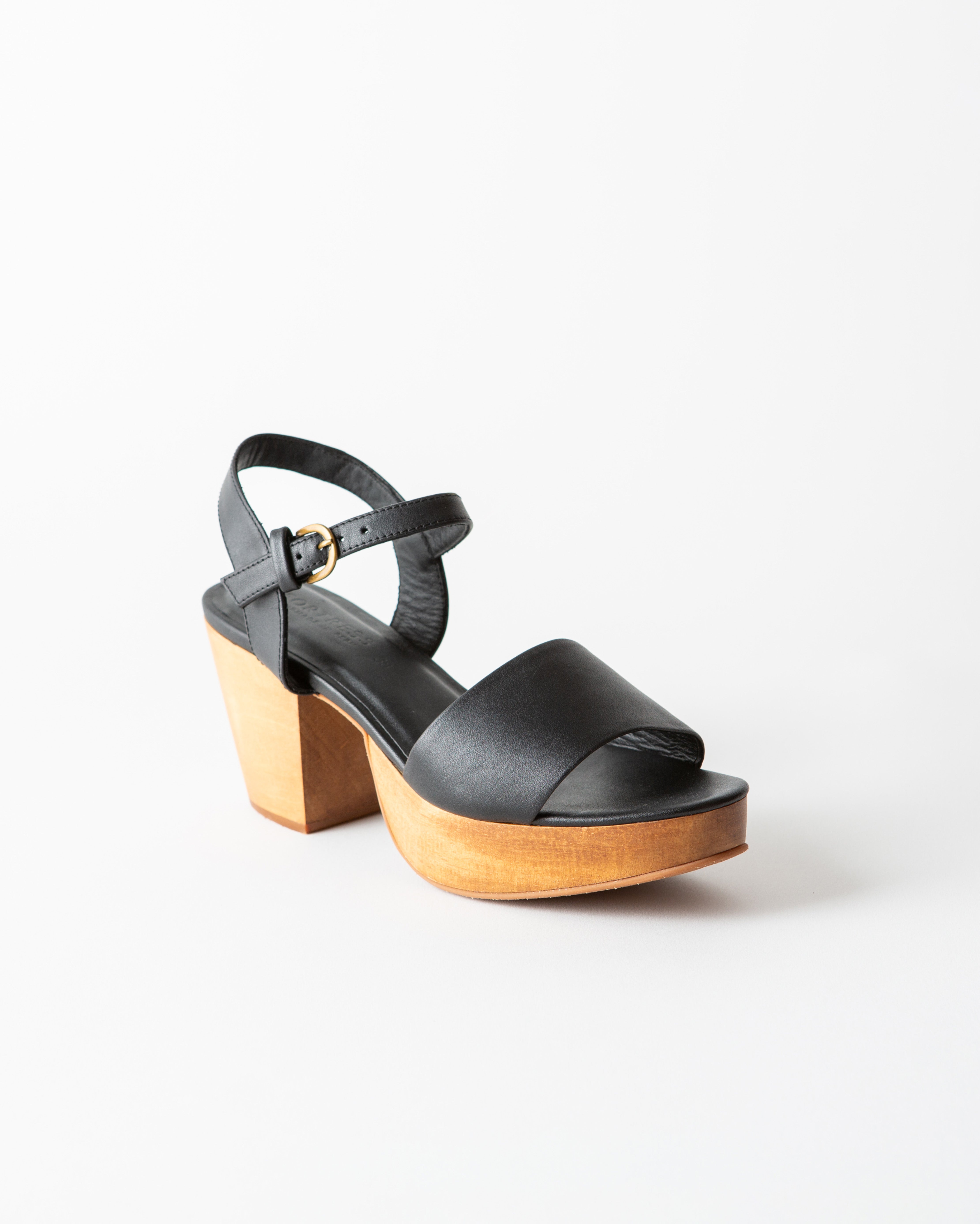black leather clog sandal on a white background