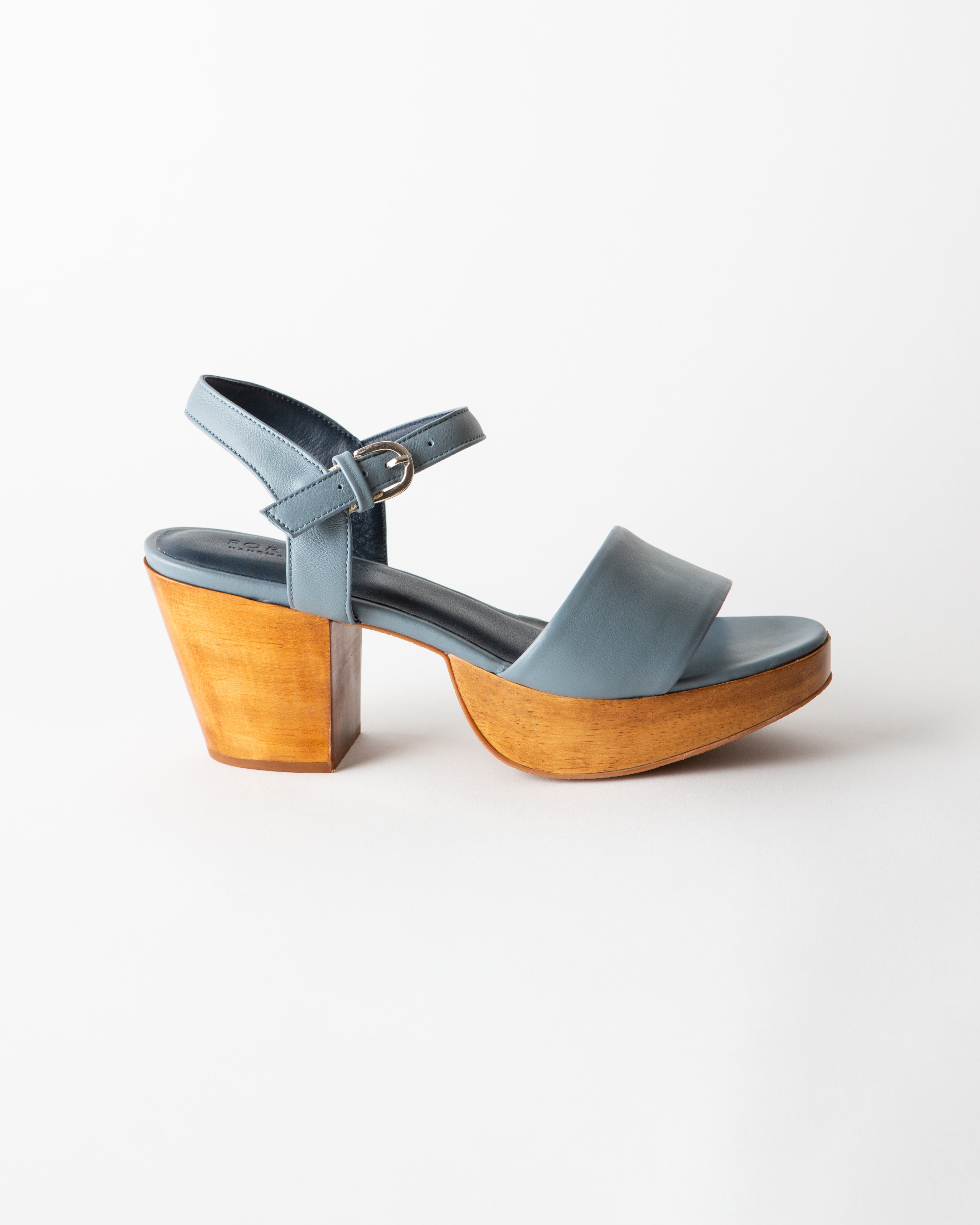 Blue sandal with wooden heel on a white background