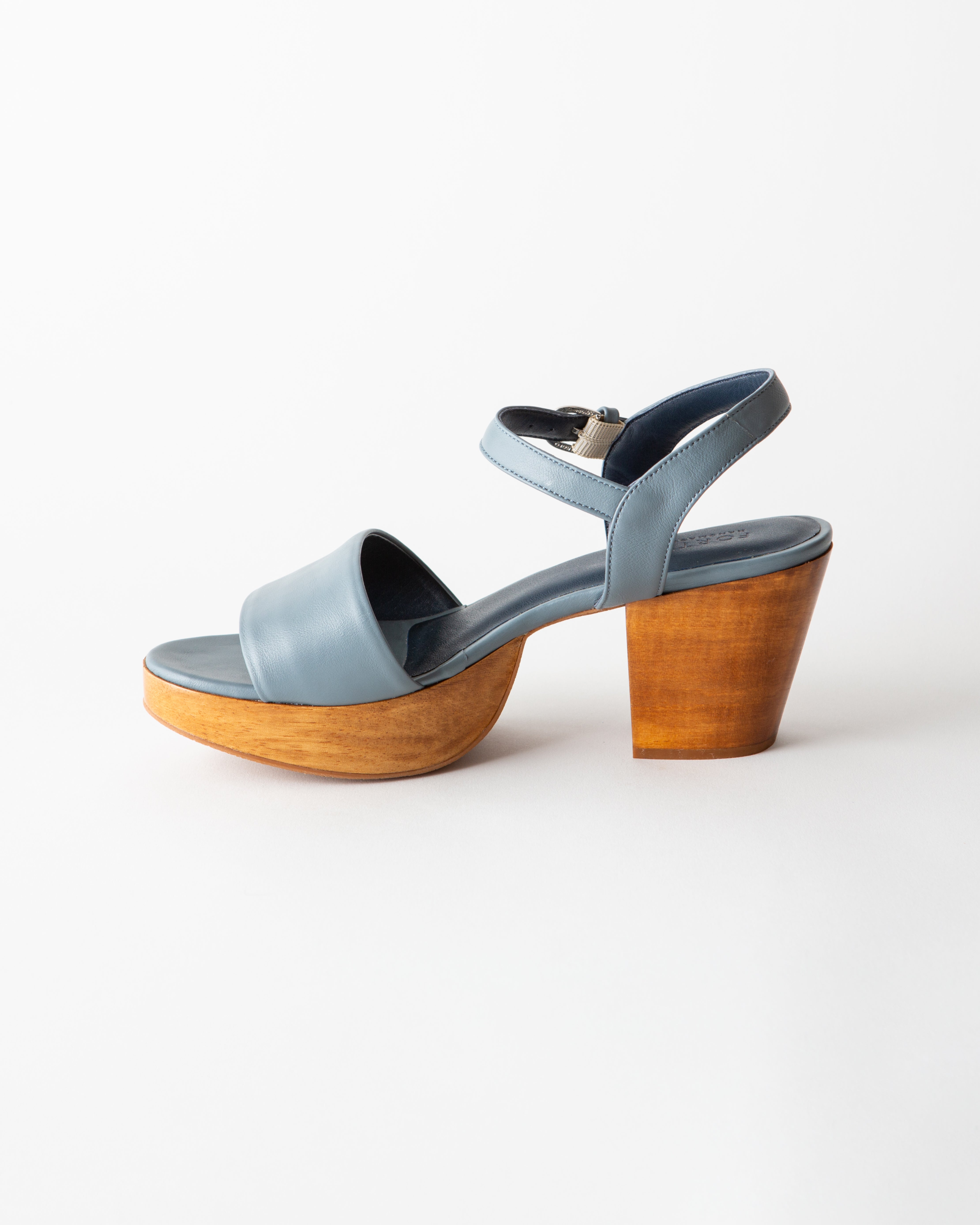 Blue sandal with wooden platform sole on a white background