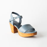 Blue sandal with wooden heel on a white background