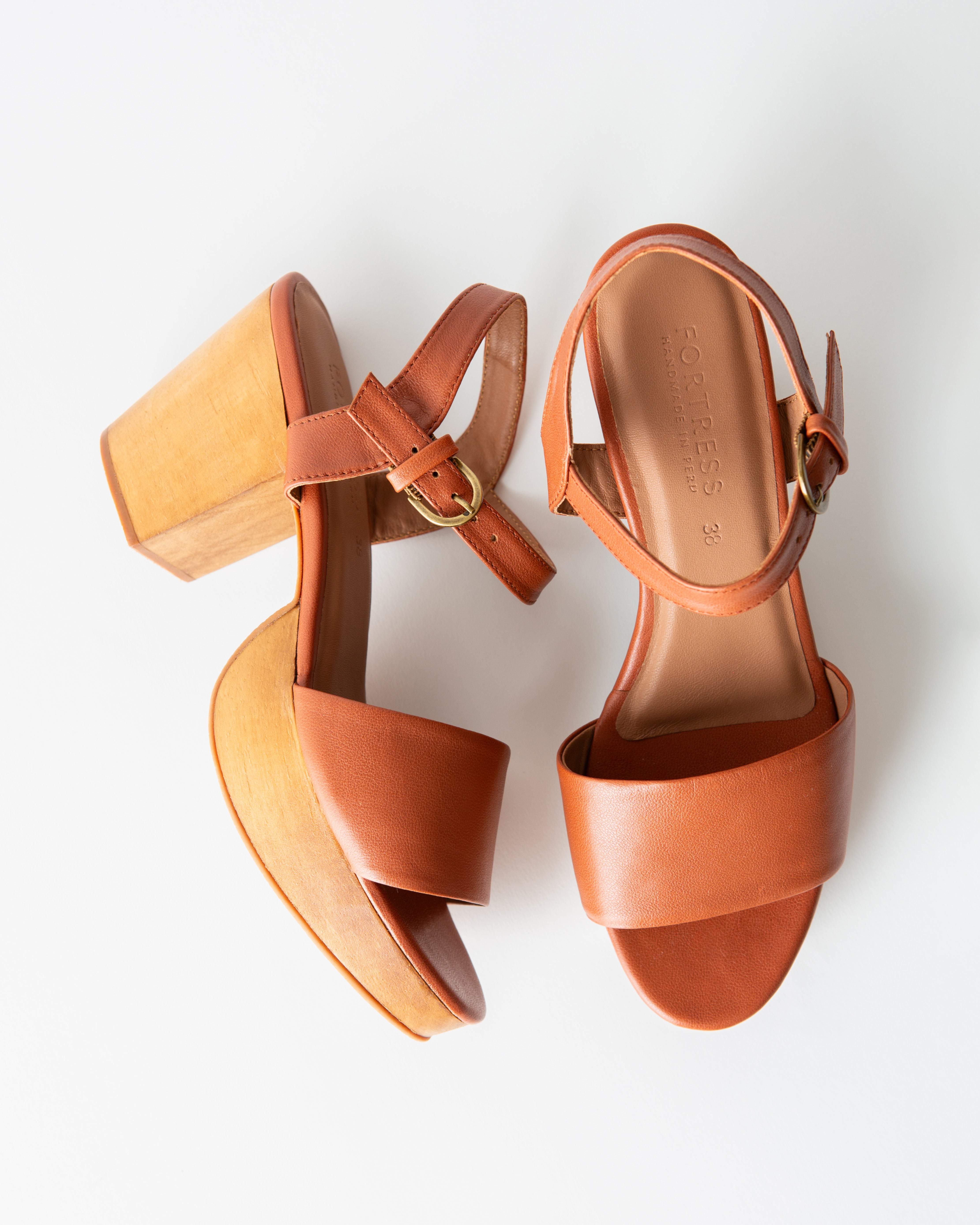 brown leather clog sandals on a white background