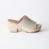 Off-white sandal with wooden platform on a white background