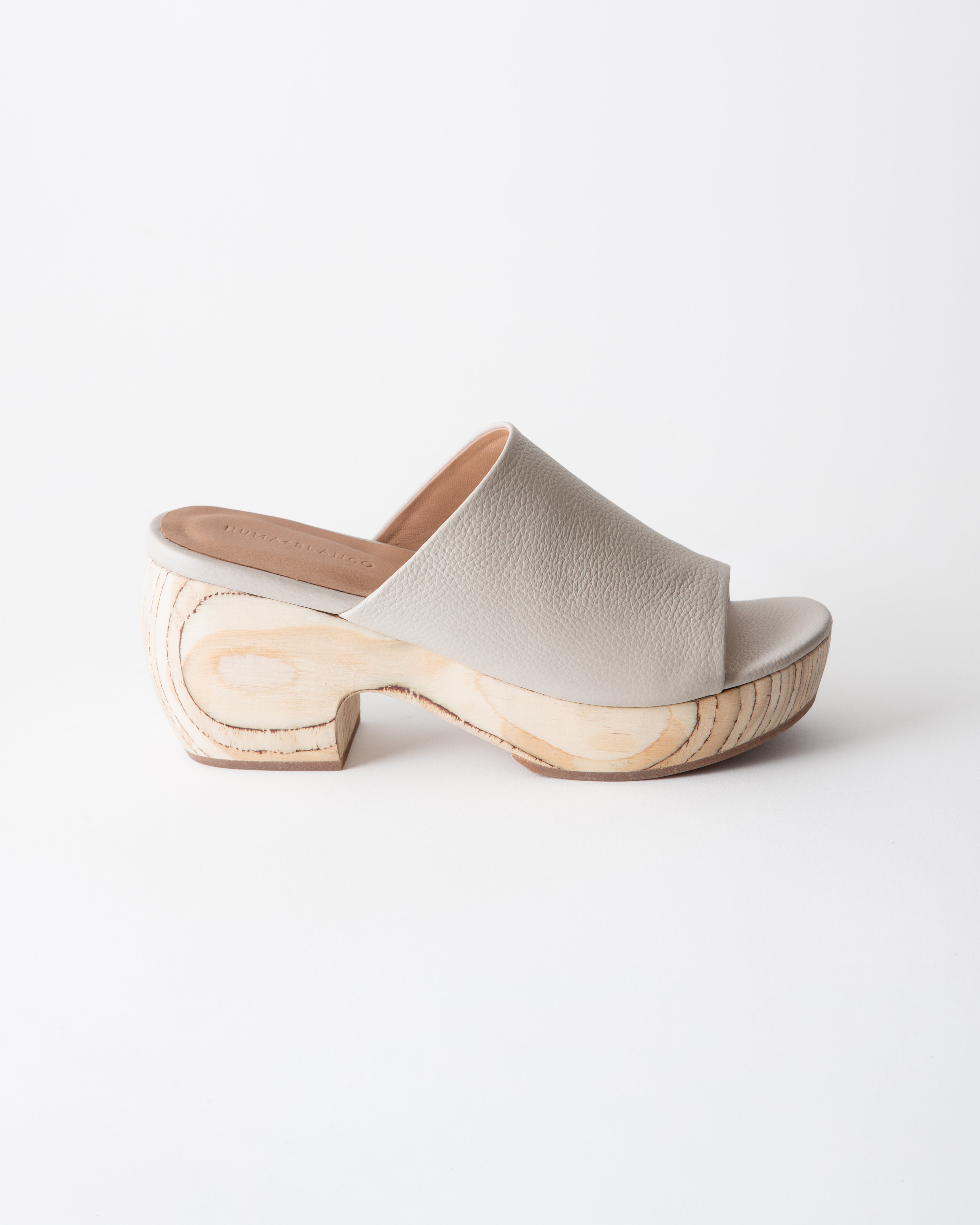 Off-white sandal with wooden platform on a white background