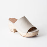 Off-white clog sandal with wooden platform on a white background