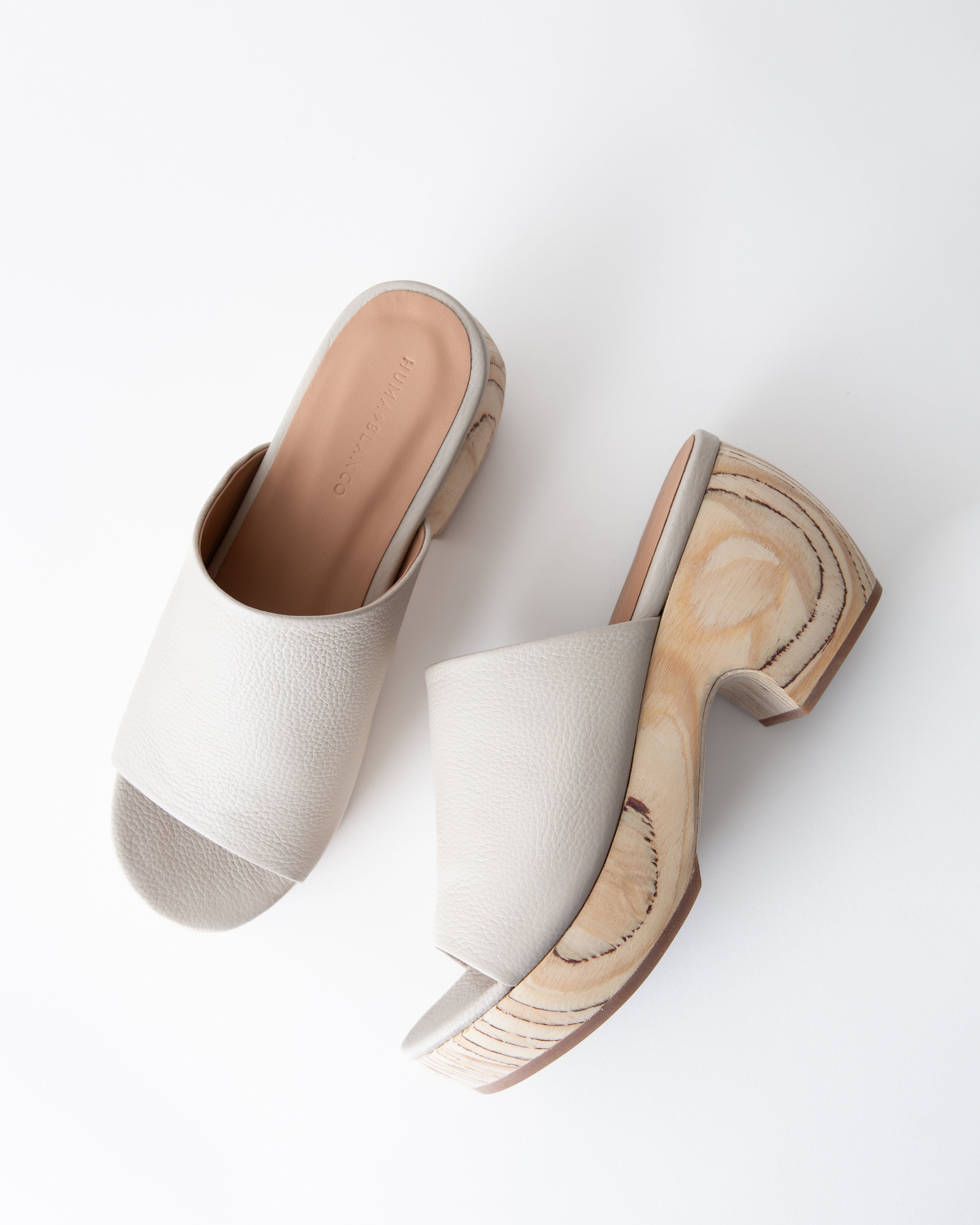Off-white clog sandals with wooden platform on a white background