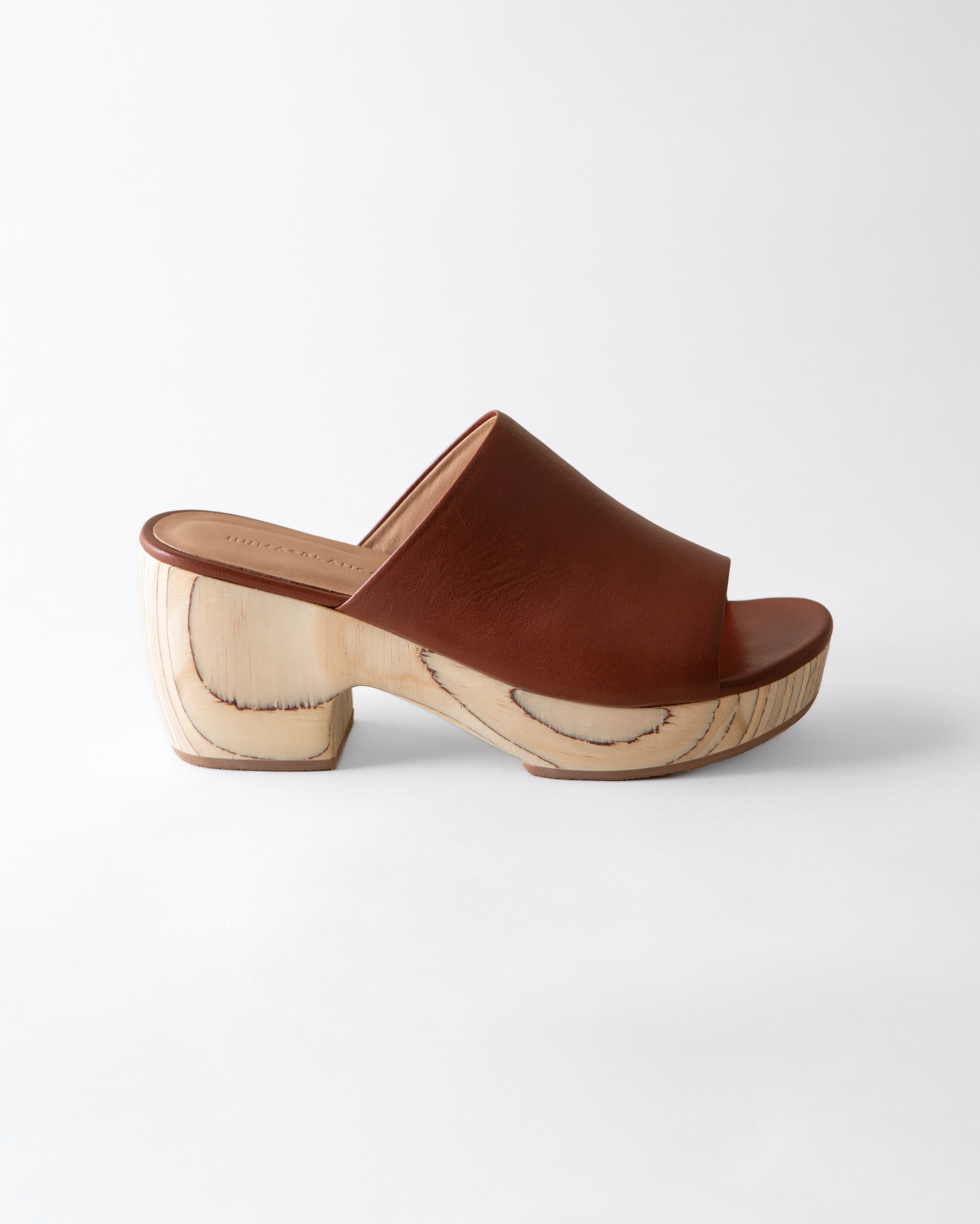 Brown wooden clog shoe on a white background