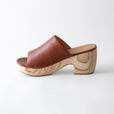 Brown leather clog shoe on a white background