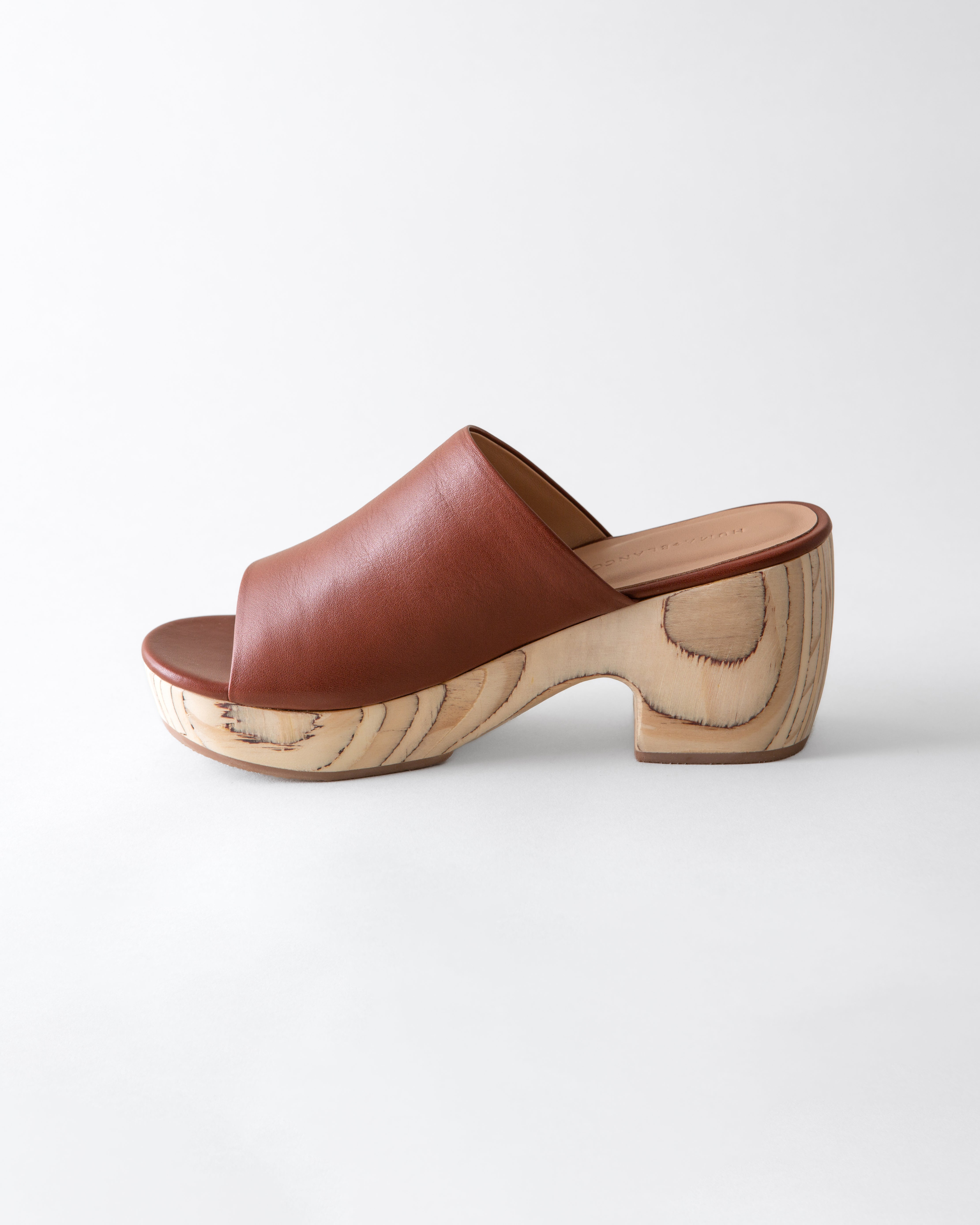 Brown leather clog shoe on a white background