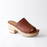Brown open-toe sandal with wooden sole on a white background