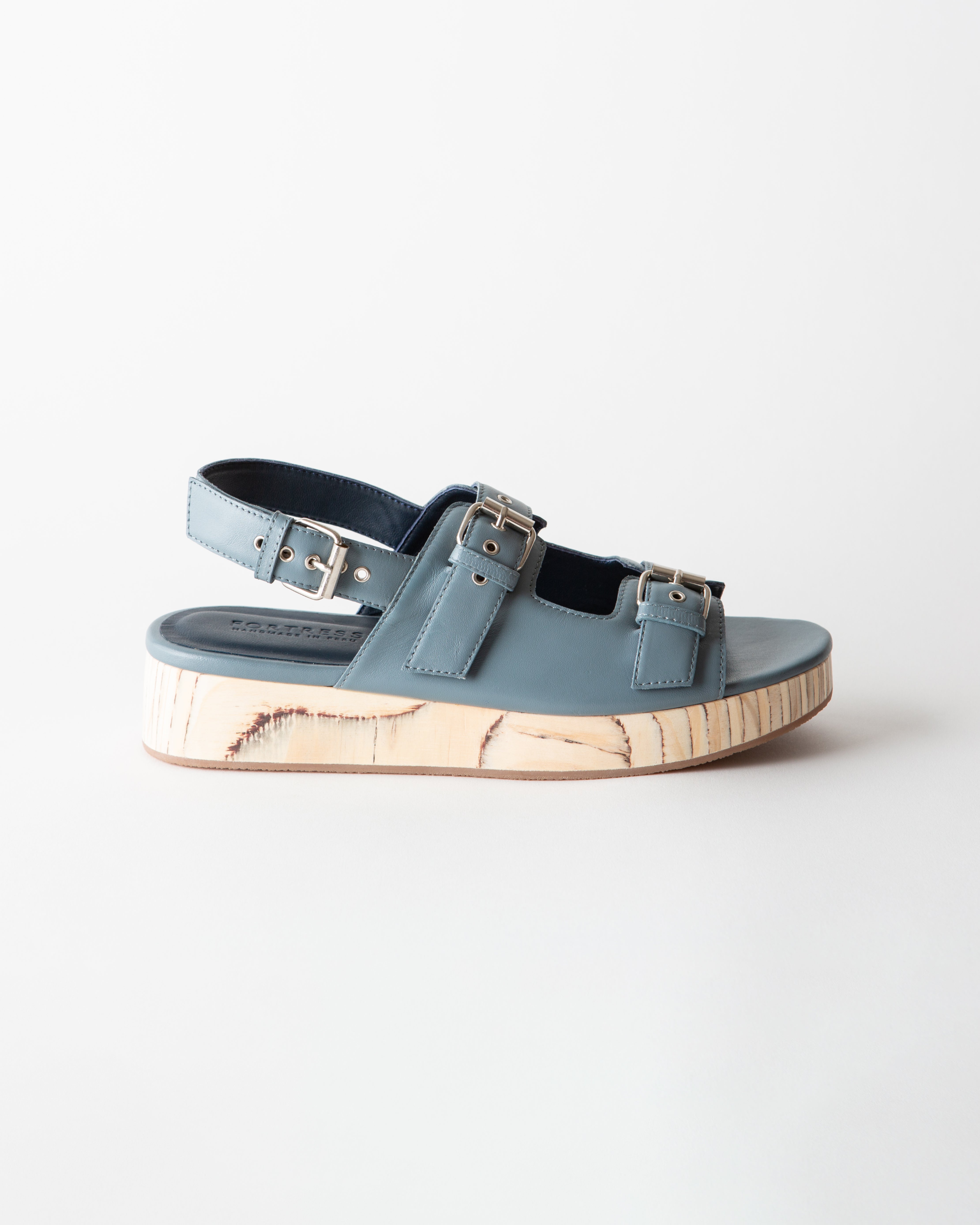 Blue sandals with cork sole on a white background