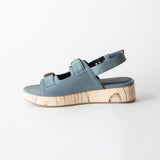 Blue sandal with wooden sole on a white background