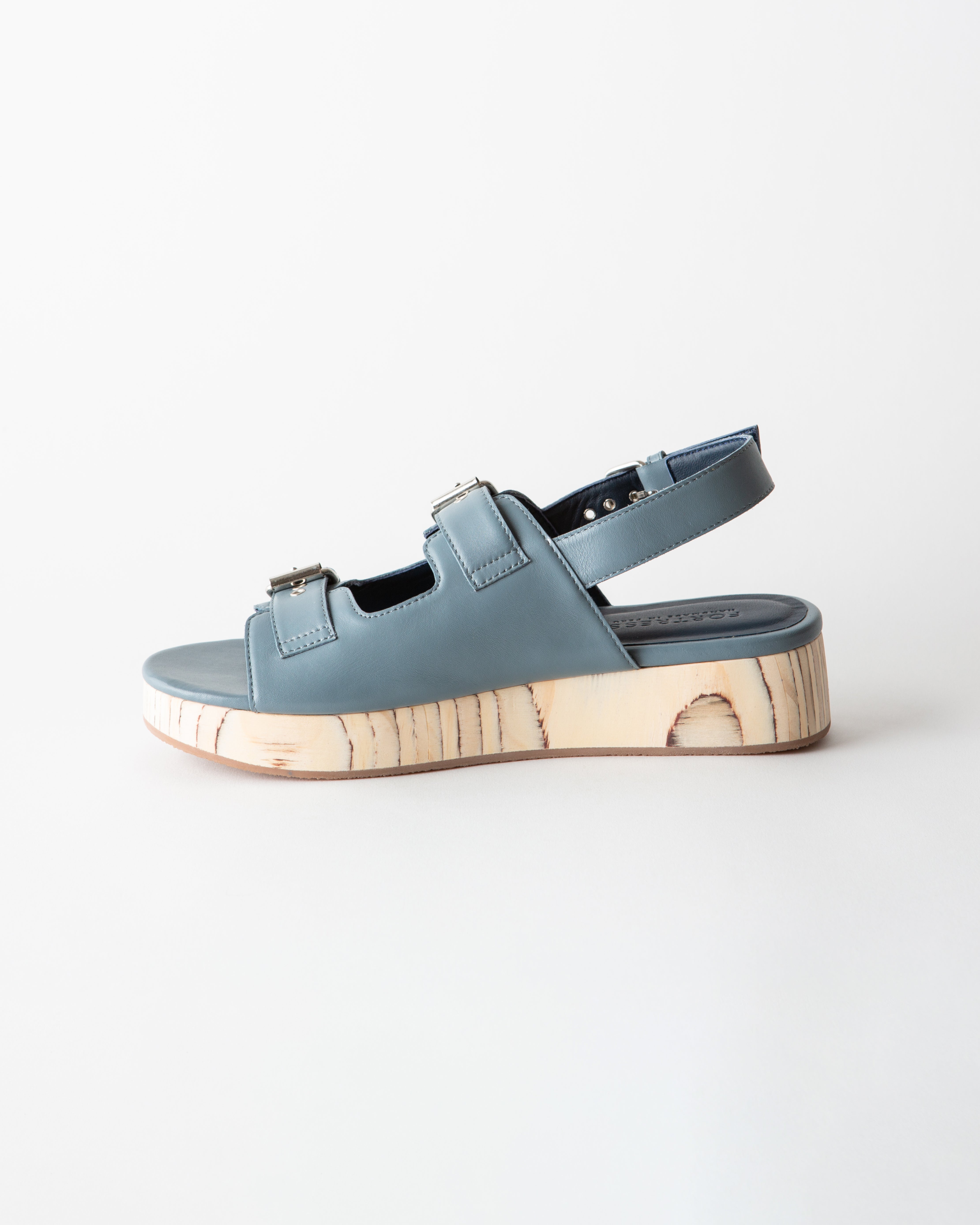 Blue sandal with wooden sole on a white background