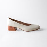 White shoe with wooden heel on a white background
