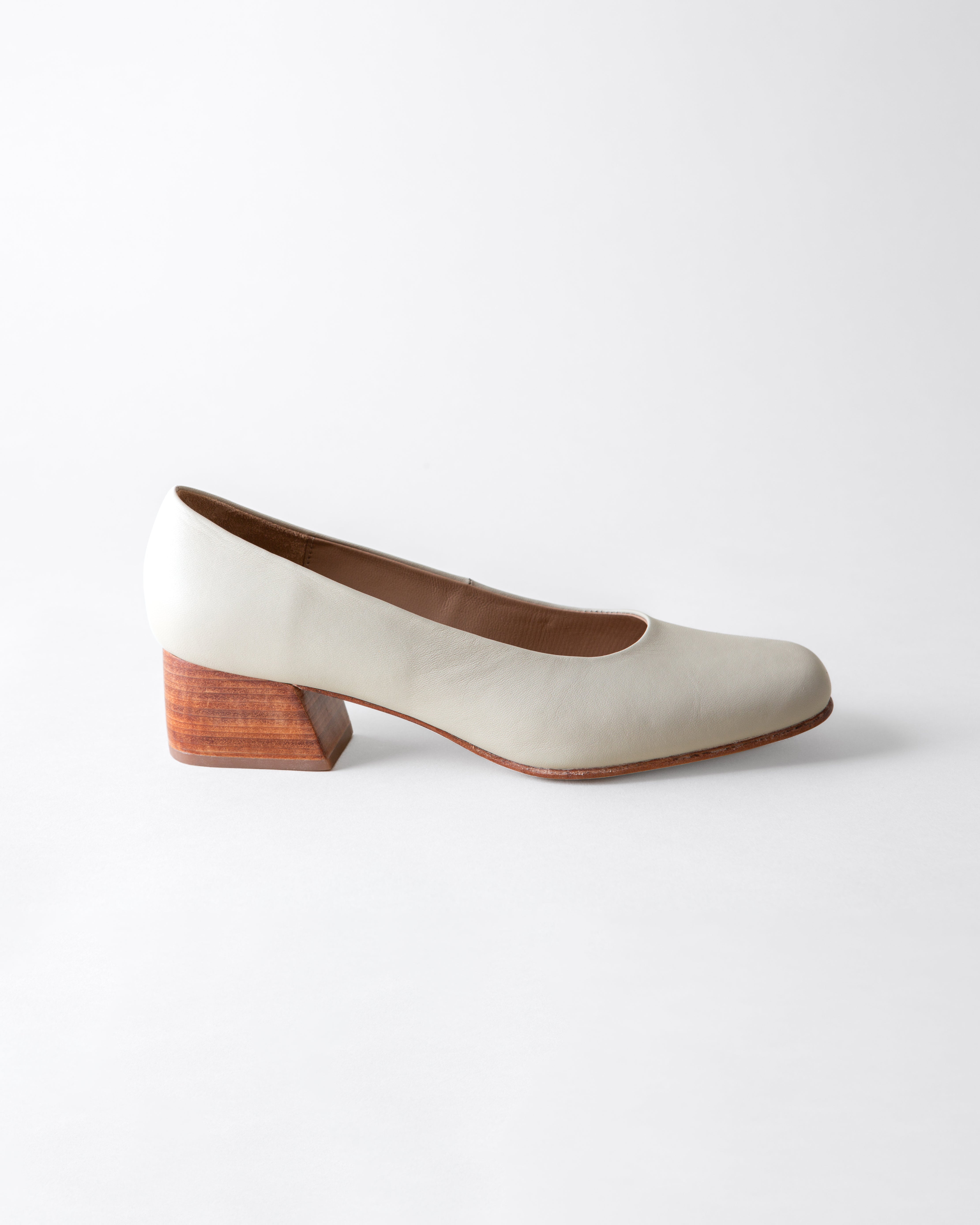White shoe with wooden heel on a white background