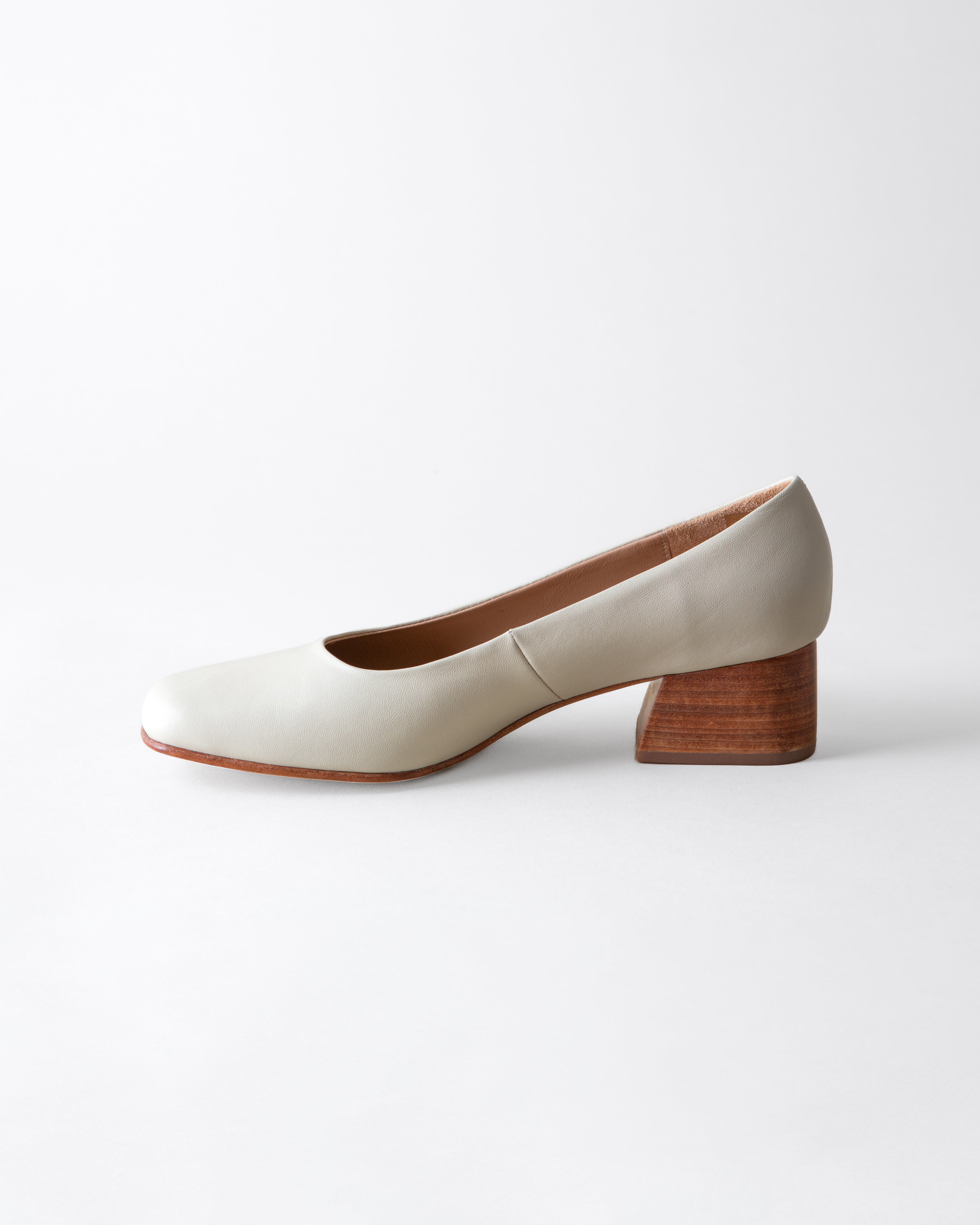 White shoe with wooden heel on a white background