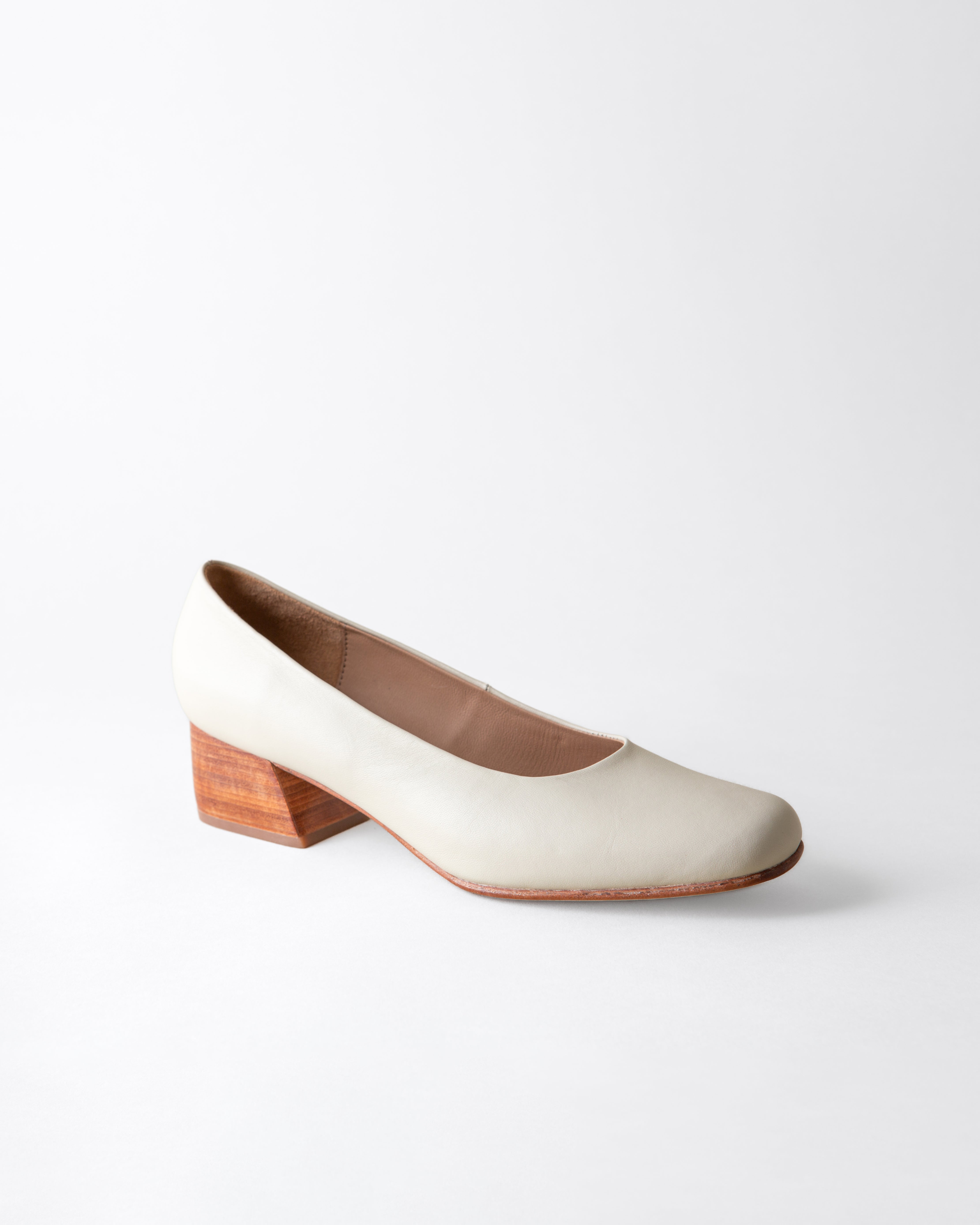 White shoe with a wooden heel on a white background