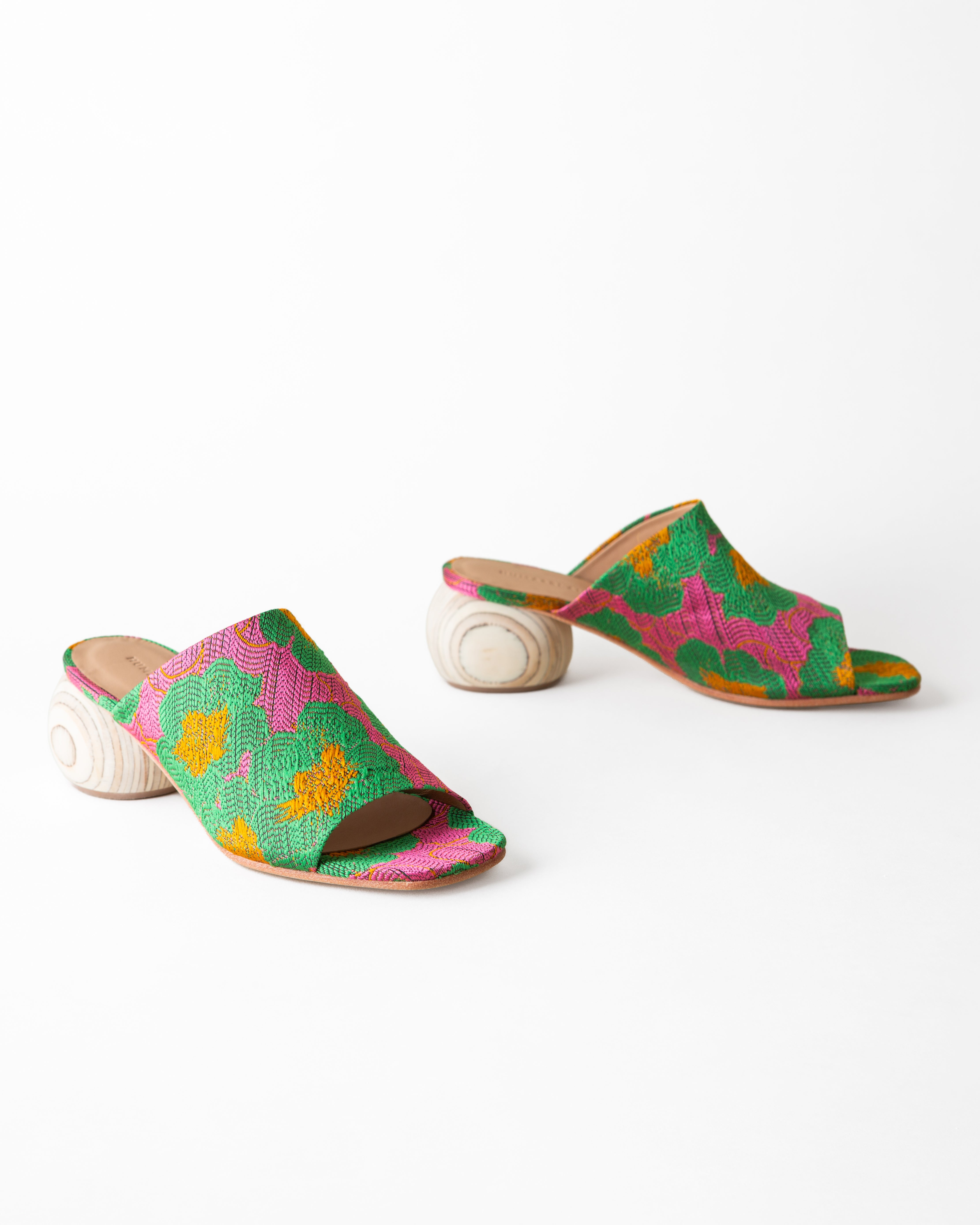 Colorful sandals with a floral pattern on a white background