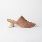 Brown suede mule shoe on a white background