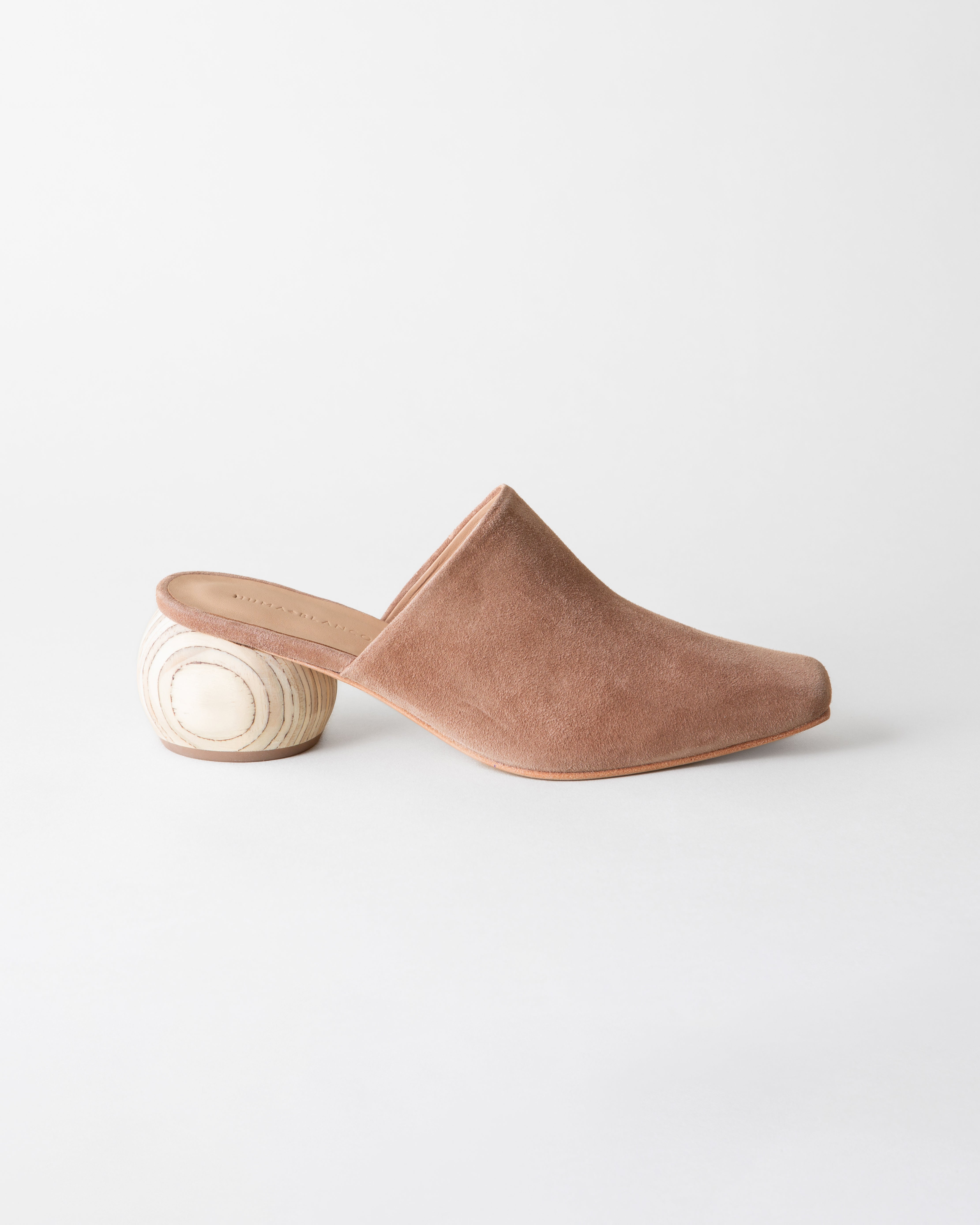 Brown suede mule shoe on a white background
