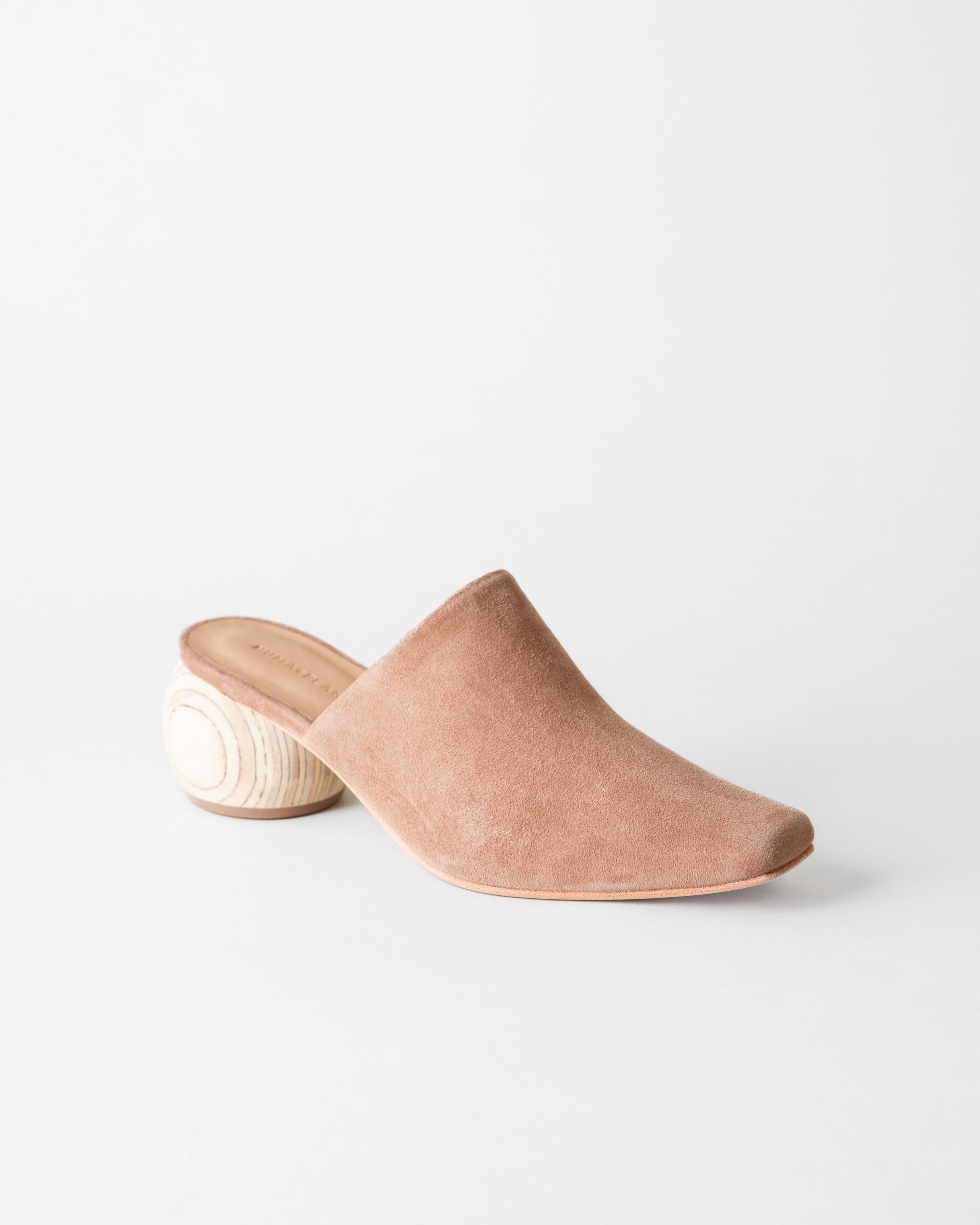 Brown suede slip-on shoe on a white background
